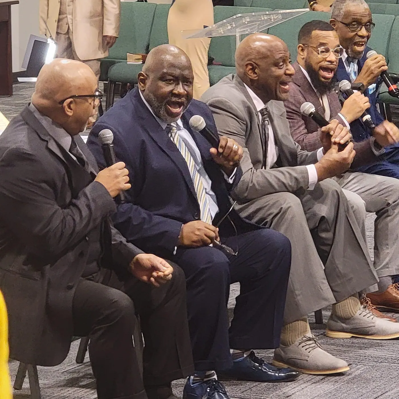 Men of the church singing together with microphones