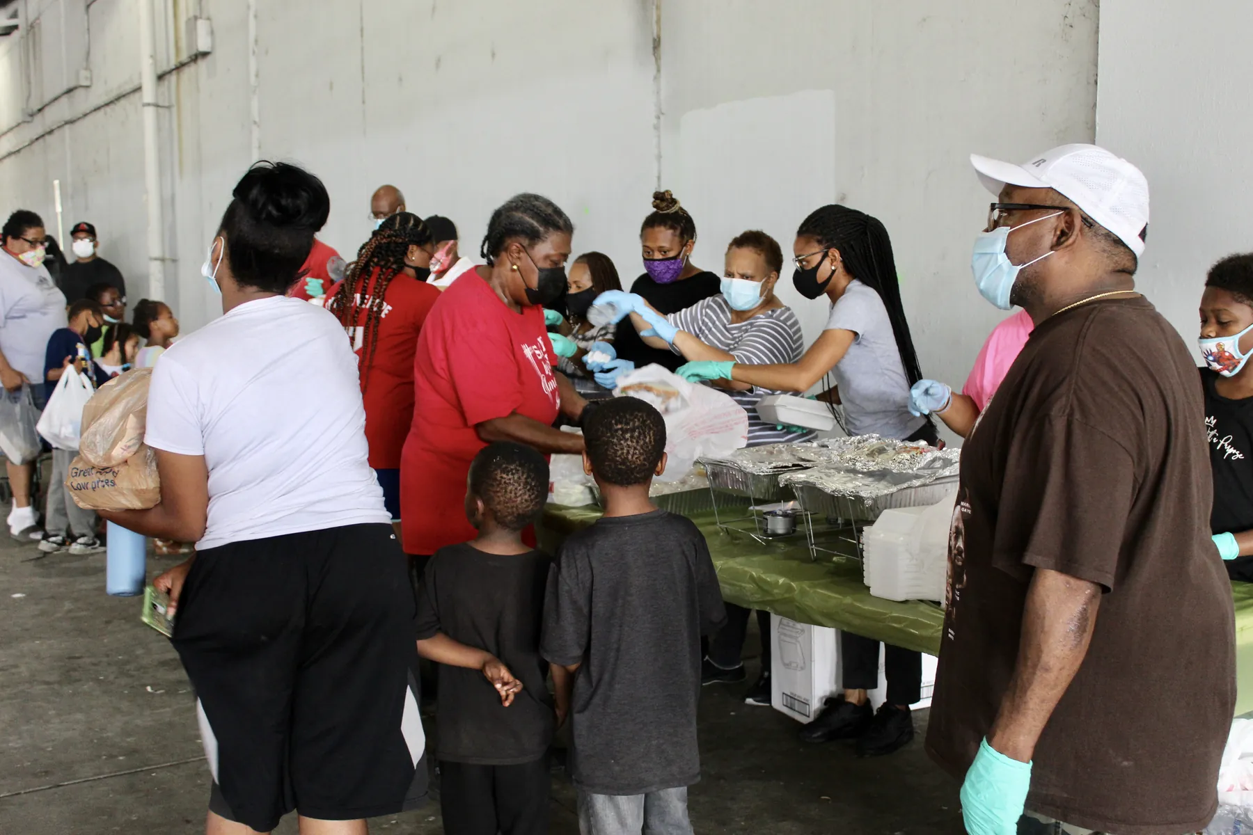 Church volunteers serving food to families at an outreach